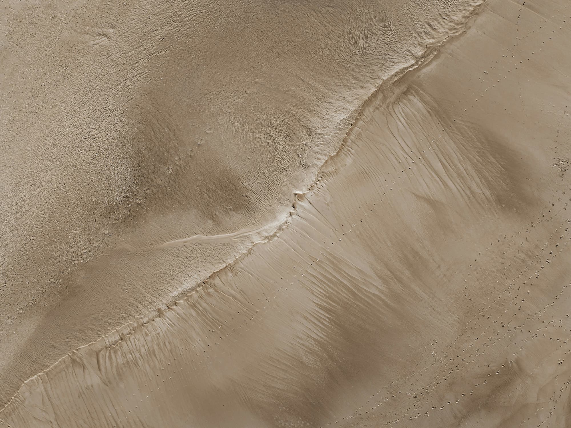 An abstract golden pattern resembling shimmering sand. 
