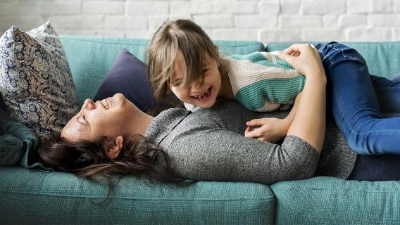 Mother and daughter having fun on the couch